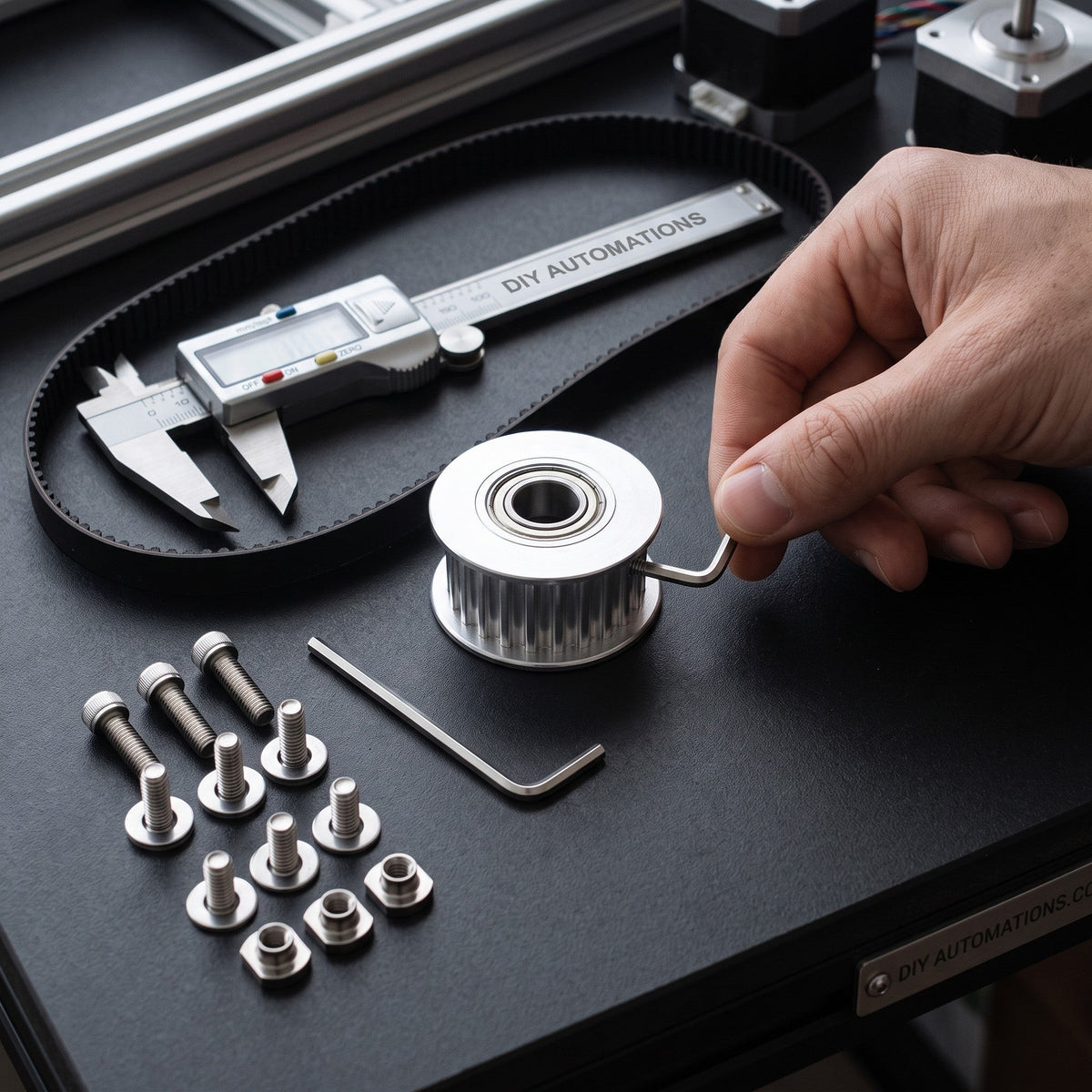 DIY AUTOMATIONS silver 20-tooth GT2 timing pulley with bearing for 6mm belt on a workbench with tools